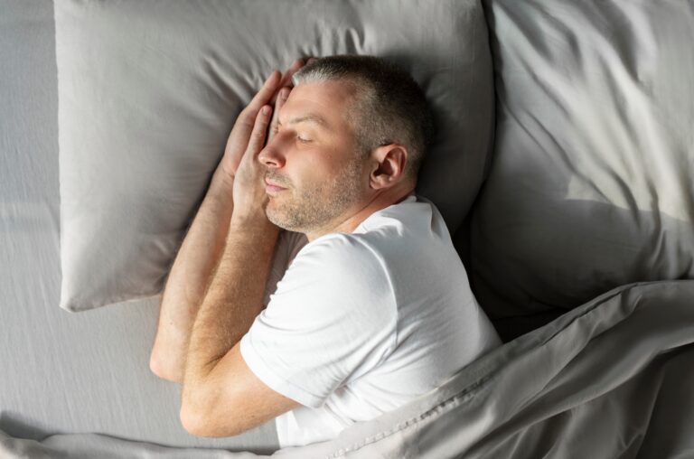 Peaceful,European,Middle,Aged,Man,Sleeping,On,Side,In,Bed